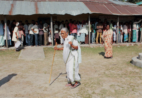 Balurghat: Voters standing in queue to cast their vote at a polling station in South Dinajpur district of West Bengal on Thursday. PTI Photo