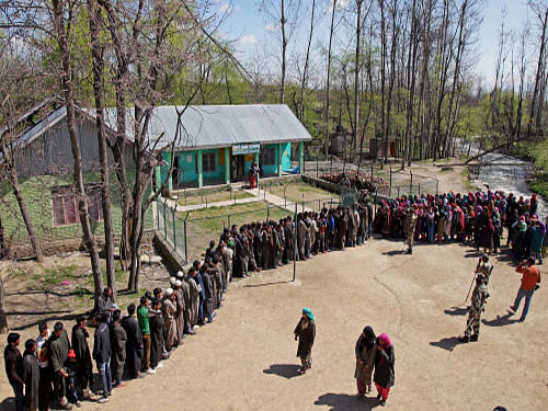 Voters wait in a long queue to cast their votes for Lok Sabha polls at a polling station in Anantnag district on Thursday. PTI Photo