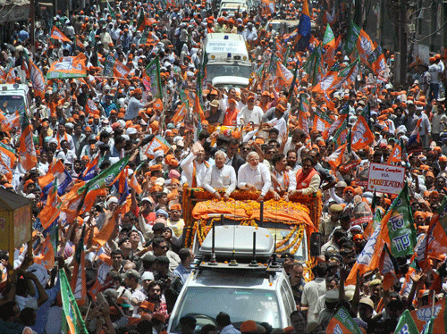BJP Prime Ministerial candidate Narendra Modi with supporters during a road show before filing his nomination papers in Varanasi on Thursday. PTI Photo