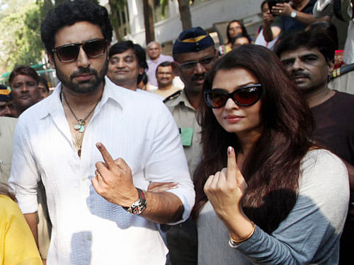 Aishwarya and Abhishek Bachchan display their inked fingers after casting votes for Lok Sabha polls in Mumbai on Thursday. Many celebrities like Priyanka Chopra, Anil Kapoor, Shabana Azmi, Javed Akhtar and Sonakshi Sinha skipped the electoral process to attend IIFA awards in the US. PTI Photo