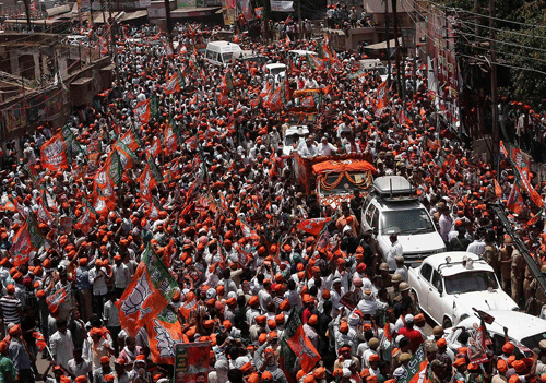 Modi waves to his supporters as he arrives to file his nomination papers for the general elections in Varanasi. Reuters