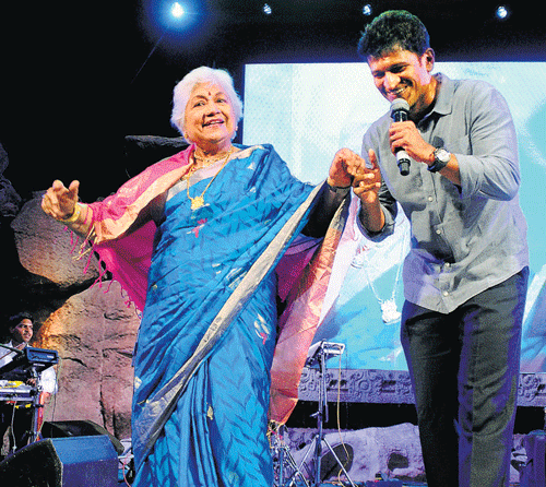 Actor SowcarJanaki dances with Puneeth Rajkumar during the 86th birth anniversary of Rajkumar.  DH photo