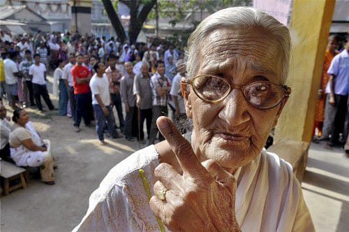 An old woman shows her inked finger after cast ing her vote for Lok Sabha elections at a polling station, in Guwahati on Thursday. PTI Photo
