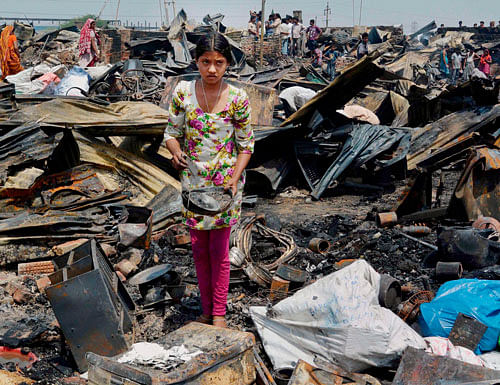 Gutted shanties after a fire at Masoodpur slum in Vasant Kunj area in New Delhi on Friday. PTI Photo