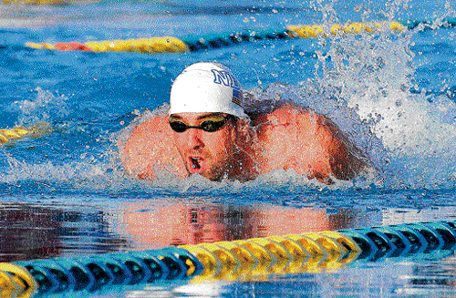making splashes: Legendary Michael Phelps competes in the 100M butterfly race on Thursday. reuters