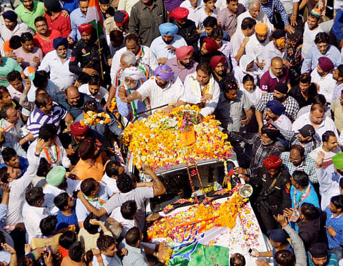 Congress candidate Capt Amarinder Singh and  Prime Minister Manmohan Singh's brother Surjit Singh Kohli during an election road show in Amritsar on Saturday. PTI