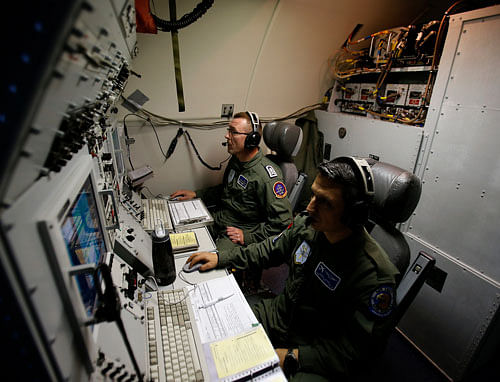 NATO E-3A Component AWACS aircraft crew, Cemil Uysal Senior Master Sgt. of Turkey, right, and Karl-Heinz Wild Senior Master Sgt. of Germany control computer and radar scope screens during a patrol over Romania and Poland, Friday, April 18, 2014. NATO performs daily AWACs surveillance flights over Poland and Romania, part of stepped up efforts to monitor airspace along the border with Ukraine. AP