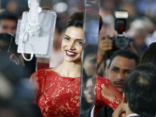 Indian film star Deepika Padukone walks the green carpet as she arrives for the 15th annual International Indian Film Awards on Saturday, April 26, 2014, in Tampa, Fla. AP Photo