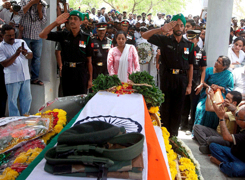 Indu Mukund paying respect to her husband Major Mukund Varadarajan who was killed in an encounter with terrorists in Shopian area of J & K last week, during his cremation in Chennai on Monday. PTI Photo