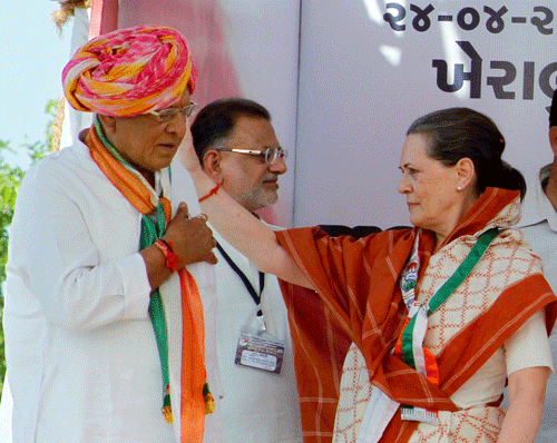 Congress president Sonia Gandhi with party leader Shankersinh Vaghela during an election rally at Kheralu village in Mahesana district of Gujarat on Thursday. PTI