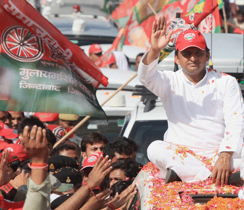 Uttar Pradesh Chief Minister Akhilesh Yadav during a road show in support of the party candidate Abhishek Mishra in Lucknow on Monday. PTI Photo