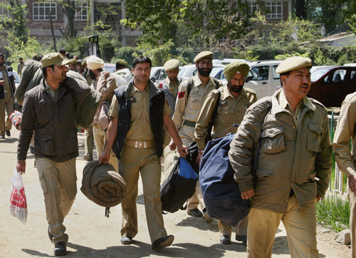 Police personnel leave for polling stations on the eve of Lok Sabha election,in Srinagar on Tuesday. PTI Photo