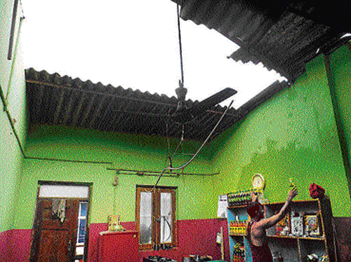 split wide open The roof of a house in Mundgod, Uttara Kannada district, was blown off by gusty winds on Tuesday.  DH PHOTO