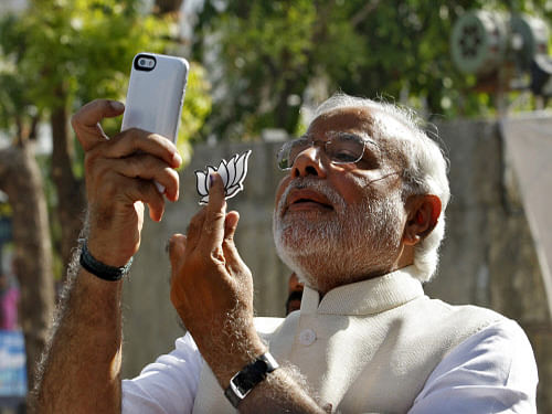 Narendra Modi, takes a 'selfie' after casting his vote at a polling station. Reuters Photo