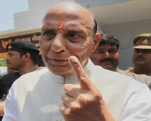 BJP President and candidate Rajnath Singh shows his inked finger after casting vote for Lok Sabha polls in Lucknow on Wednesday. PTI Photo