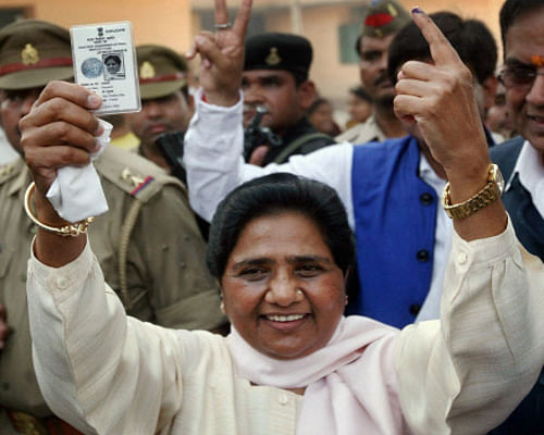 BSP supremo Mayawati shows her voter identity card and 'inked' finger after casting her vote in Lucknow on Wednesday. PTI Photo
