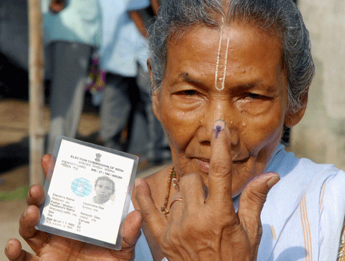 An old woman showing her inked finger after casting vote at a polling station at Chunchura in Hooghly district of West Bengal on Wednesday during 7th phase of Lok Sabha elections. PTI Photo