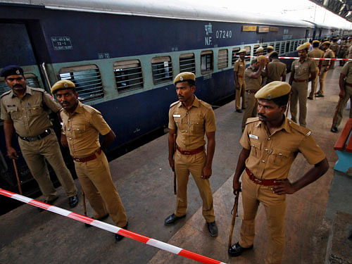 Policemen stand guard next to a passenger train in which two explosions occurred, at the railway station in Chennai May 1, 2014. Two explosions ripped through a passenger train in Chennai on Thursday, killing a 22 year-old female passenger, officials said. The blasts occurred in two coaches just as the train was approaching the city's central station. A total of nine people were injured, two of them seriously, in addition to the dead passenger. REUTERS