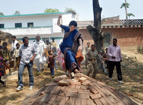 Priyanka Vadra breaks away from her SPG cordon to meet people in a village in Amethi to campaign for her brother Rahul Gandhi on Thursday. PTI Photo