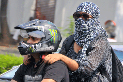 It is now mandatory for woman pillion riders to wear helmets in the national capital. File photo - DH
