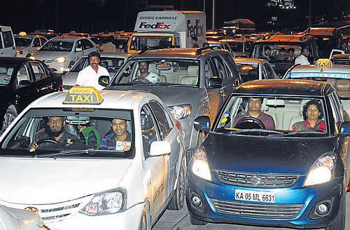 Vehicles pile up as taxi drivers refuse to pay the increased toll in Bangalore on Saturday. dh photo/s k dinesh