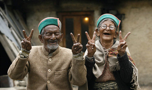 Shyam Sharan Negi, 97, first voter of India with his wife Hira Mani Negi shows victory sign at his village Kalpa near Recongpeo, Kinnour. PTI Image