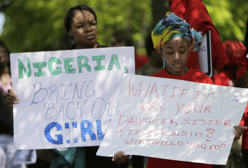 Protesters hold signs during a march in support of the girls kidnapped by members of Boko Haram in front of the Nigerian Embassy in Washington. Reuters photo