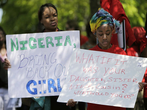 Protesters hold signs during a march in support of girls kidnapped by members of Boko Haram in front of the Nigerian Embassy in Washington. The number of Nigerian girls taken in the latest kidnapping by Boko Haram Islamists has risen to 11, an official in the restive northeast said today. Reuters photo