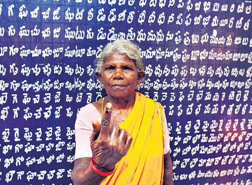 A voter shows her ink-marked finger after casting her vote at a polling station in Chittor district, Andhra Pradesh on Wednesday REUTERS
