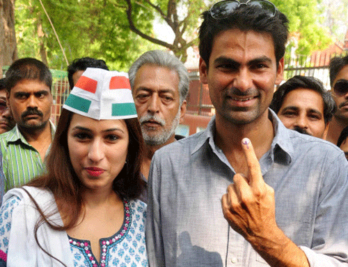 Cricketer and Congress candidate Mohd. Kaif for Phulpur seat with his wife Pooja Yadav shows his ink mark finger after casting vote for 8th phase of Lok Sabha Election in Phulpur on Wednesday. PTI Photo