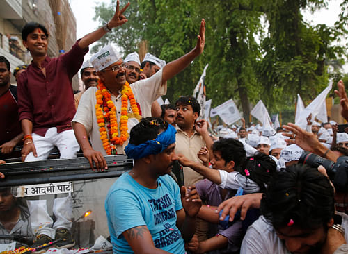 AAP chief Arvind Kejriwal waves at supporters during an election campaign rally in Varanasi. AP
