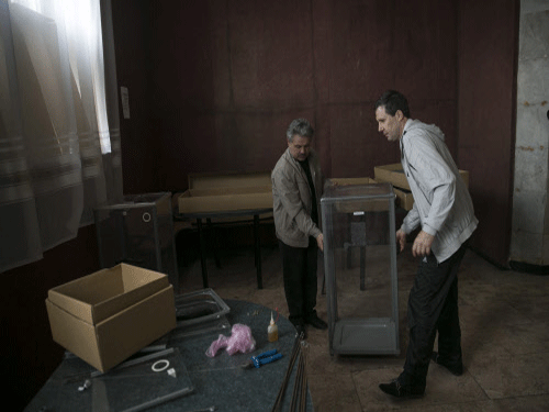 Election commission workers carry a ballot box at a polling station ahead of Sunday's referendum in the eastern Ukrainian city of Slaviansk. Acting Ukrainian President Oleksander Turchinov told eastern regions gripped by a pro-Russian uprising that they would be courting catastrophe if they voted 'yes' in a separatist referendum. Reuters photo