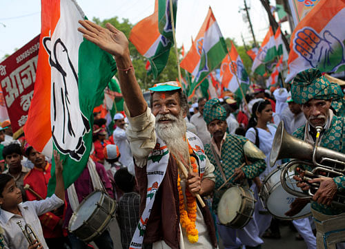 A supporter of Congress Vice President Rahul Gandhi dance during an election campaign rally in Varanasi. AP