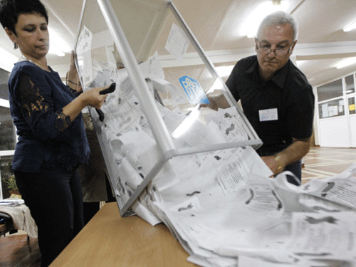 Members of a local election commission empty a ballot box as they start counting votes. Pro-Russian rebels late Sunday claimed voters in eastern Ukraine massively backed independence in a disputed poll that Kiev and the West dismissed as an illegal 'farce'. Reuters photo