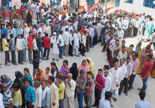 Voters stand in long queues to cast their votes for Last phase of Lok Sabha polls in Varanasi on Monday. PTI