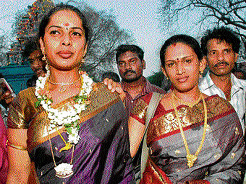 Two transgenders pose after tying the mangalsutra