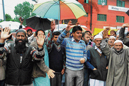 Panchayat members stage a protest demanding probe into the killings of village heads in Srinagar on Monday. PTI photo