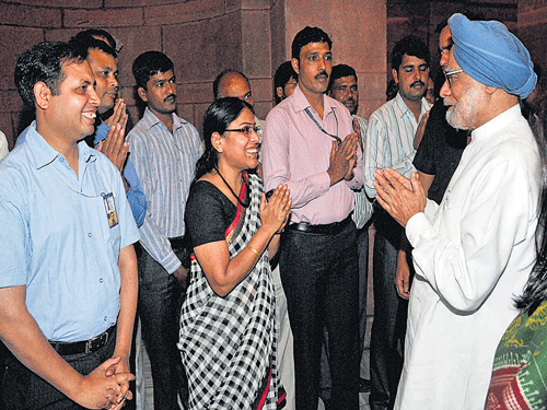 Prime Minister Manmohan Singh bidding farewell to the staff at the PMO in New Delhi on Tuesday. PTI photo
