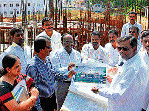 Revenue and District in-charge Minister&#8200;V&#8200;Sreenivas Prasad inspects the works of Dr&#8200;B&#8200;R&#8200;Ambedkar Bhavan, in Mysore, on Wednesday. MLA Vasu, and others are seen. DH PHOTO