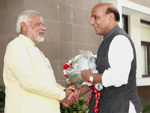 BJP President Rajnath Singh greets party's prime minister candidate and Gujarat Chief Minister Narendra Modi at CM's house in Gandhinagar on Wednesday. PTI Photo