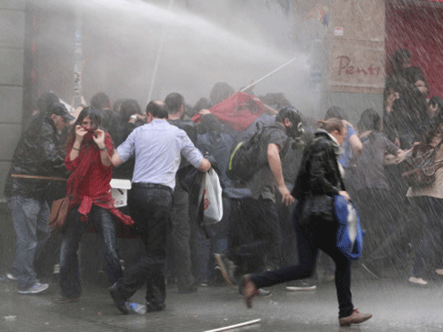 Protesters run away from water canon fired by the riot police during a demonstration blaming the ruling AK Party (AKP) government for the mining disaster in western Turkey. Turkey's biggest union has called for a massive strike today amid mounting anger over the country's worst mining accident, which claimed at least 274 lives with many more still trapped underground. Reuters photo
