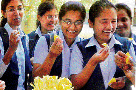 Students savour jackfruits on display on the UAS campus in Bangalore on Thursday. dh photo