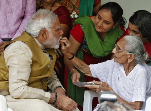 Narendra Modi  the prime ministerial candidate for Bharatiya Janata Party , seeks blessings from his mother Heeraben at her residence in Gandhinagar, Gujarat May 16, 2014.  Reuters photo