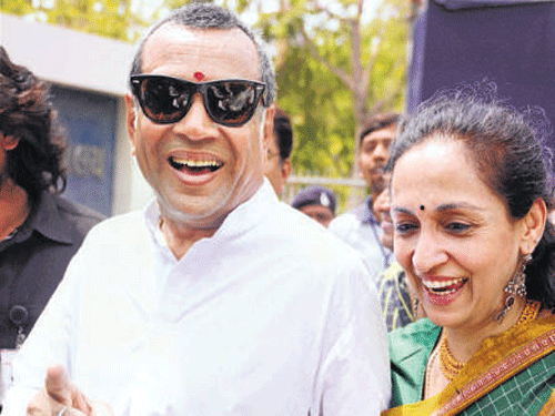 BJP's Paresh Rawal along with his wife flashes victory sign. PTI photo