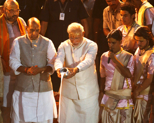BJP leader and India's next prime minister Narendra Modi performs evening rituals, with BJP President Rajnath Singh, front left, and Amit Shah, background left, standing by on the banks of the River Ganges in Varanasi, an ancient city revered by millions of devout Hindus, Saturday, May 17, 2014.  AP Photo