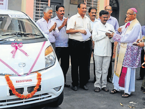Mangalore Bishop Rev Dr Aloysius Paul D'Souza inaugurates Rachana- Catholic Chamber of Commerce and Industry self-employment scheme by handing over the Tata Nano key to the first beneficiary of 'Nano Taxi' plan Jayaprakash Fernandes, at Bishop's House, in Mangalore, on Saturday. DH photo