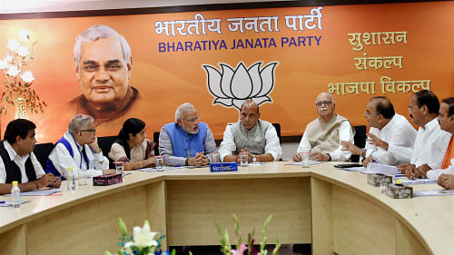 Bharatiya Janata Party leader and the next Prime Minister Narendra Modi with party president Rajnath Singh, senior leader LK Advani and other leaders during the party's parliamentary board meeting in New Delhi on Saturday. PTI Photo