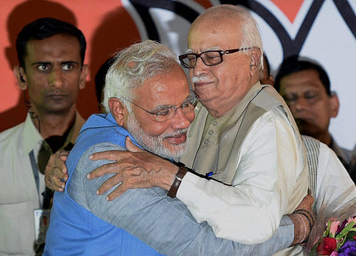 Bharatiya Janata Party leader and the next Prime Minister Narendra Modi hugs senior party leader L K Advani at a felicitation function at the party headquarters in New Delhi on Saturday. PTI Photo