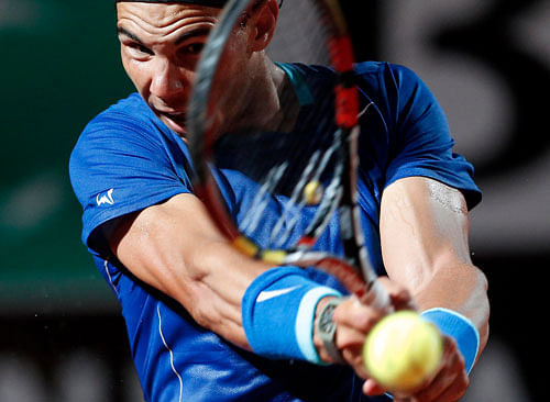 Rafael Nadal of Spain returns the ball to Grigor Dimitrov of Bulgaria in their men's singles semi-final match at the Rome Masters tennis tournament May 17, 2014. REUTERS