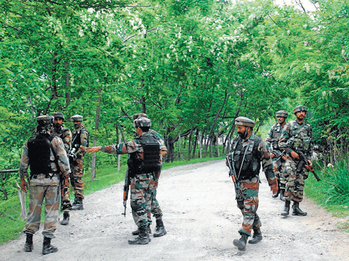 Army soldiers during an encounter with militants at Kaiser Mulla village in Chadoora area of district Budgam on Monday. PTI
